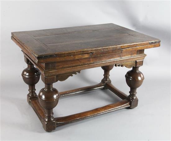 A mid 17th century Dutch oak draw leaf table extended 7ft 1.5in.